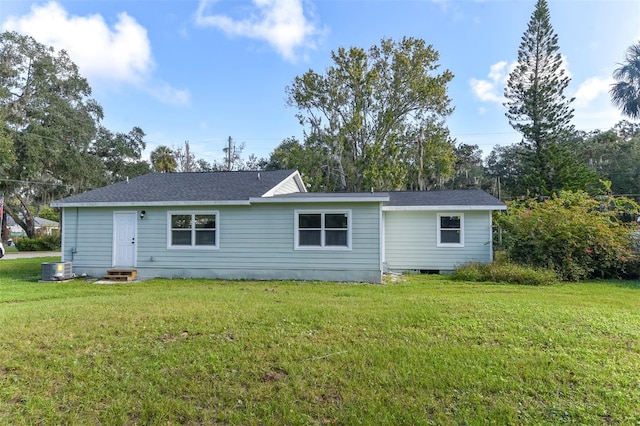 rear view of house featuring a yard and cooling unit