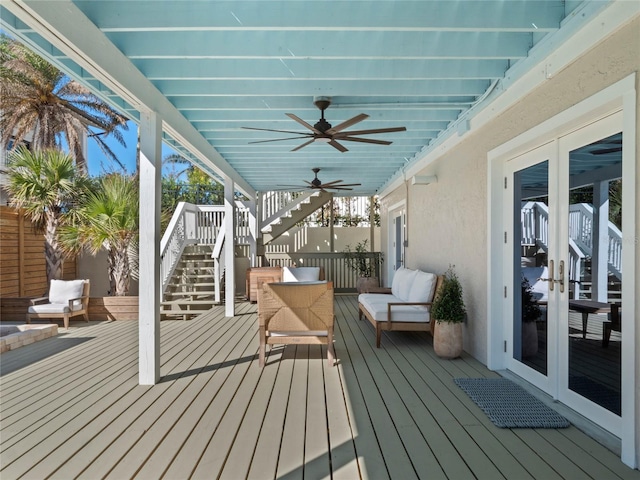 wooden deck featuring ceiling fan, outdoor lounge area, and french doors