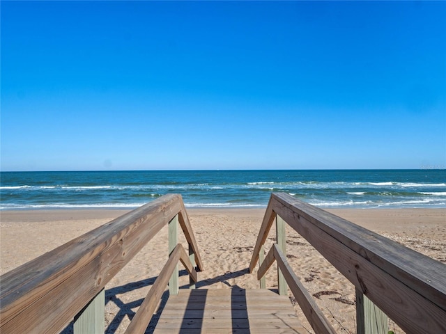 view of property's community featuring a beach view and a water view