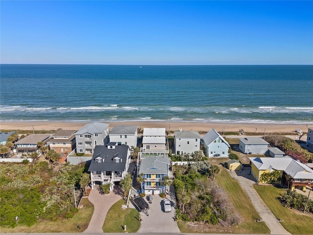 bird's eye view featuring a water view and a view of the beach