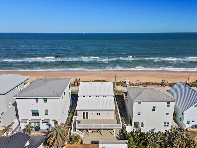 aerial view with a water view and a beach view