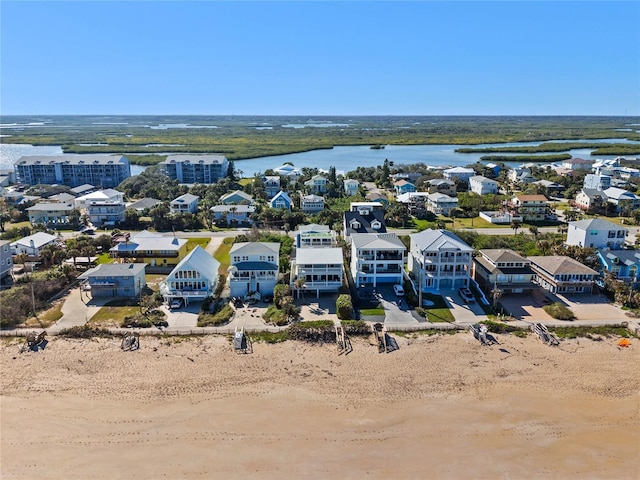 bird's eye view featuring a water view and a beach view