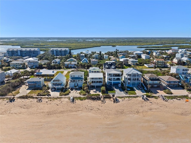 bird's eye view featuring a water view and a view of the beach