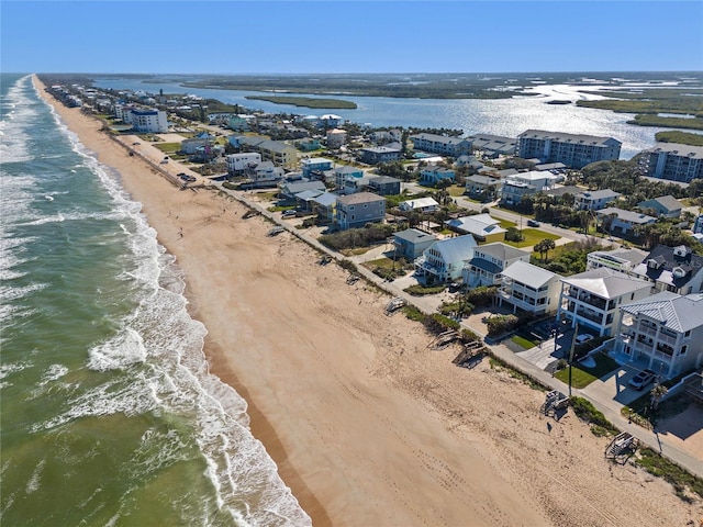 drone / aerial view with a water view and a view of the beach