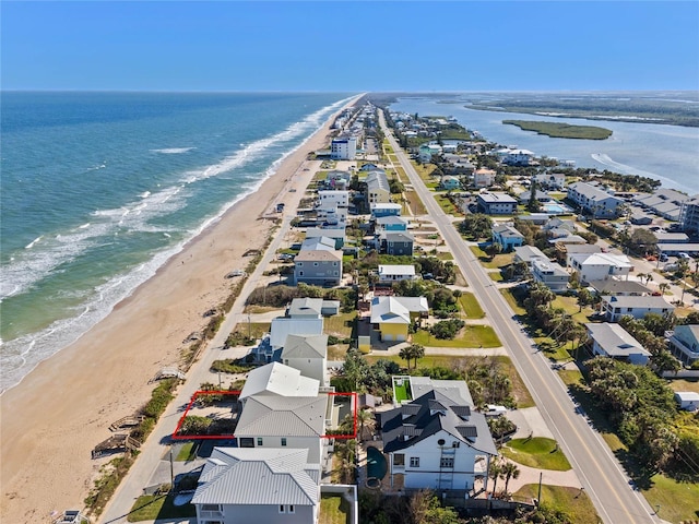 aerial view with a water view and a view of the beach