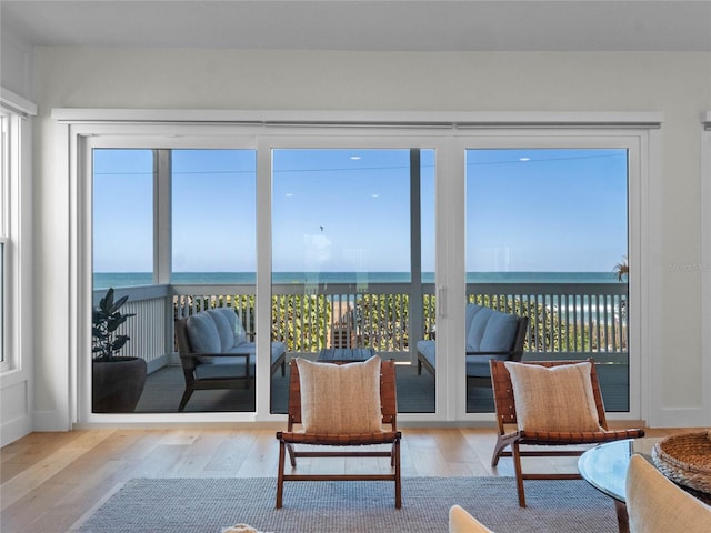 sunroom featuring a water view and plenty of natural light