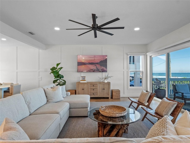 living room featuring hardwood / wood-style flooring and ceiling fan