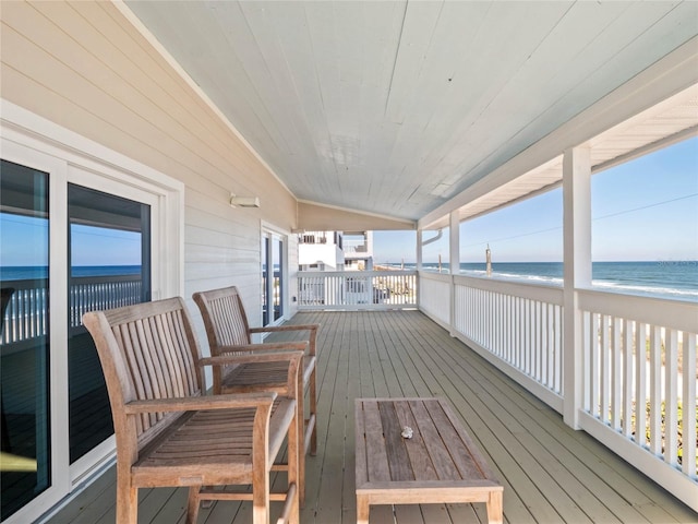 deck featuring a beach view and a water view