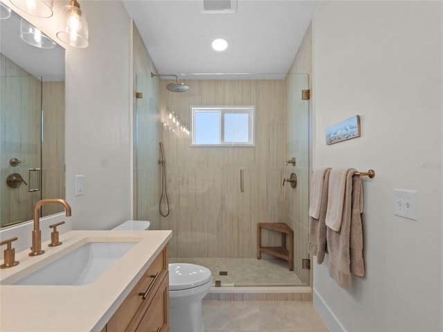 bathroom with a shower with shower door, tile patterned floors, toilet, and vanity