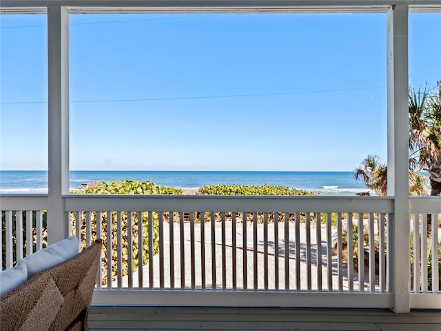 exterior space featuring a water view and a view of the beach