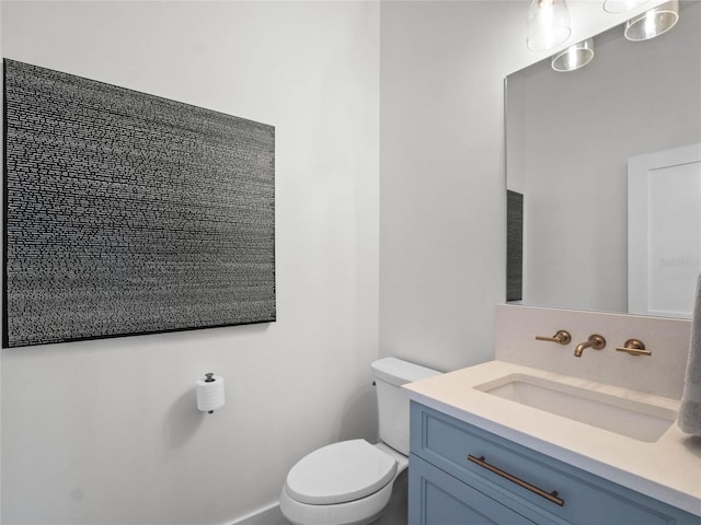 bathroom with toilet and vanity