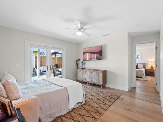 bedroom featuring ceiling fan, light hardwood / wood-style floors, access to outside, and french doors