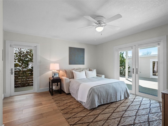 bedroom featuring ceiling fan, french doors, hardwood / wood-style flooring, a textured ceiling, and access to exterior