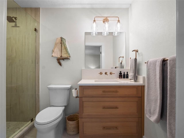 bathroom with vanity, toilet, and a shower with door