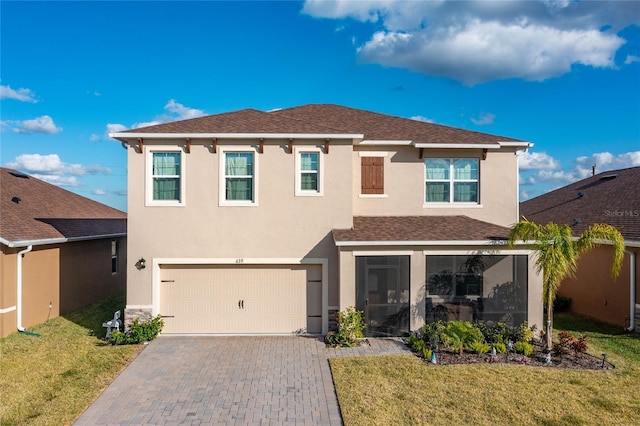 view of front of house with a garage and a front yard