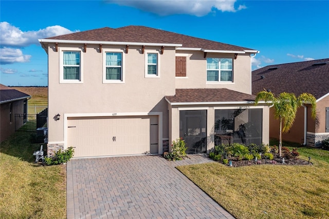 view of front of home featuring a front lawn and a garage