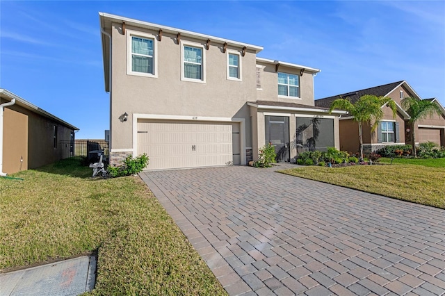 view of front facade with a front yard and a garage