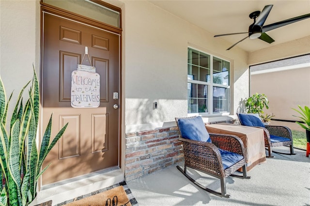 entrance to property with ceiling fan and a porch