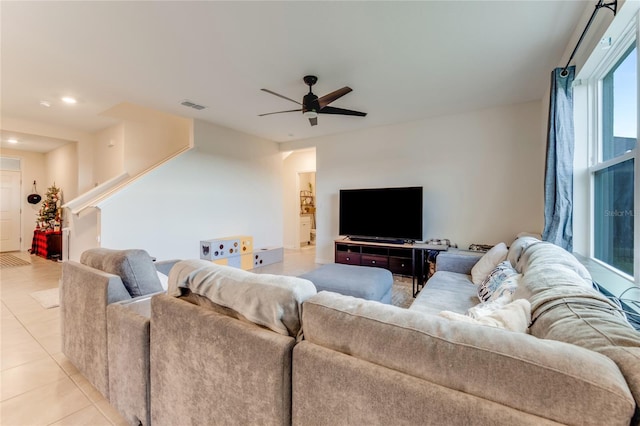 living room with ceiling fan and light tile patterned flooring