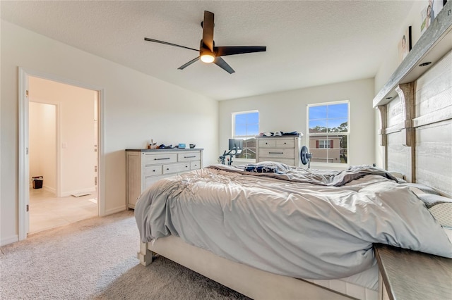 carpeted bedroom with a textured ceiling and ceiling fan