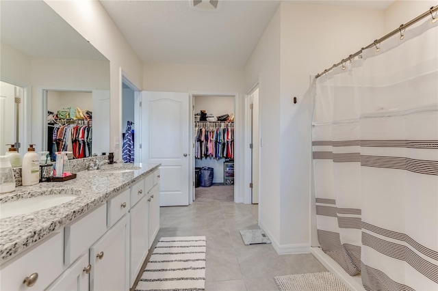 bathroom with tile patterned floors, vanity, and a shower with shower curtain