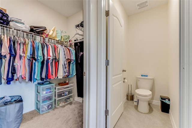 spacious closet featuring light carpet