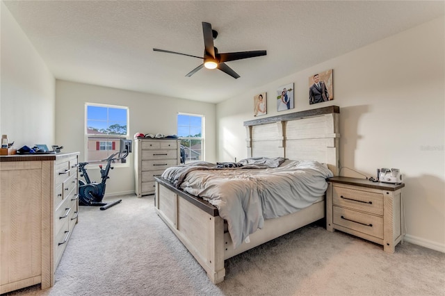 carpeted bedroom with a textured ceiling and ceiling fan