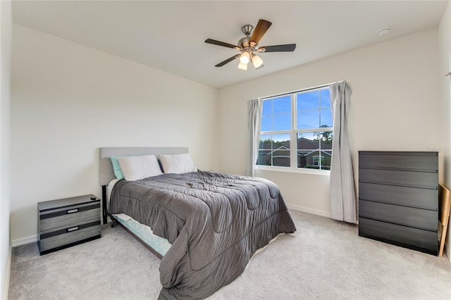 bedroom featuring ceiling fan and light colored carpet