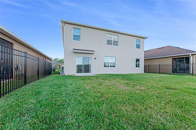 back of property featuring a lawn