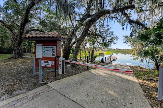 exterior space featuring a water view and a dock