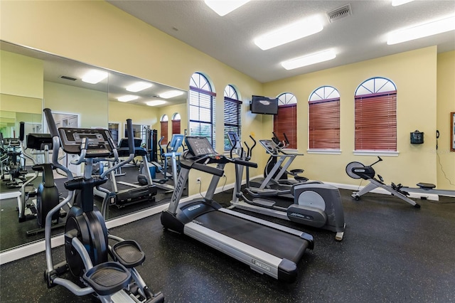 exercise room featuring a textured ceiling