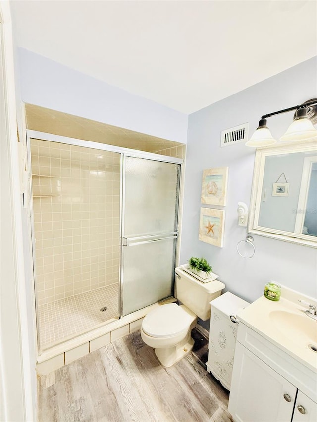 824 Garfish Ave, New Smyrna Beach, FL 32169 - full bath featuring vanity, wood finished floors, toilet, and a stall shower