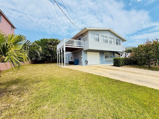 824 Garfish Ave, New Smyrna Beach, FL 32169 - back of property featuring a garage, concrete driveway, and a lawn