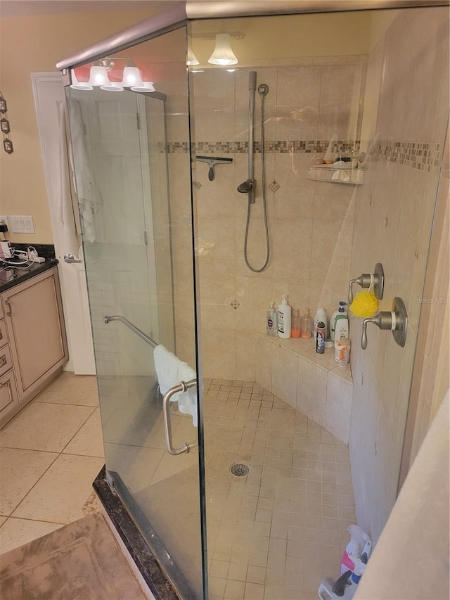 bathroom featuring tile patterned floors, vanity, and walk in shower