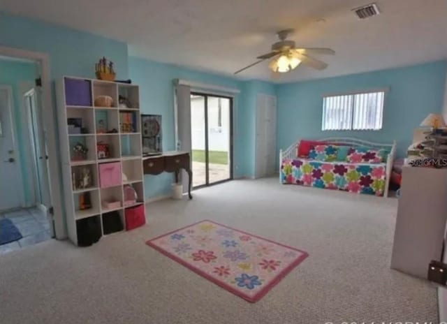 bedroom with access to exterior, ceiling fan, and carpet floors