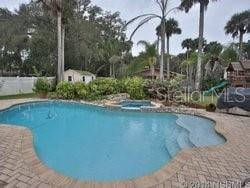 view of swimming pool with an in ground hot tub