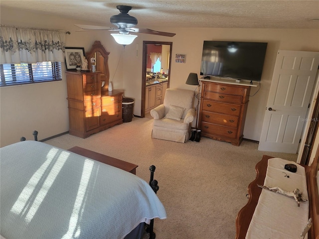 carpeted bedroom with ceiling fan, a textured ceiling, and connected bathroom