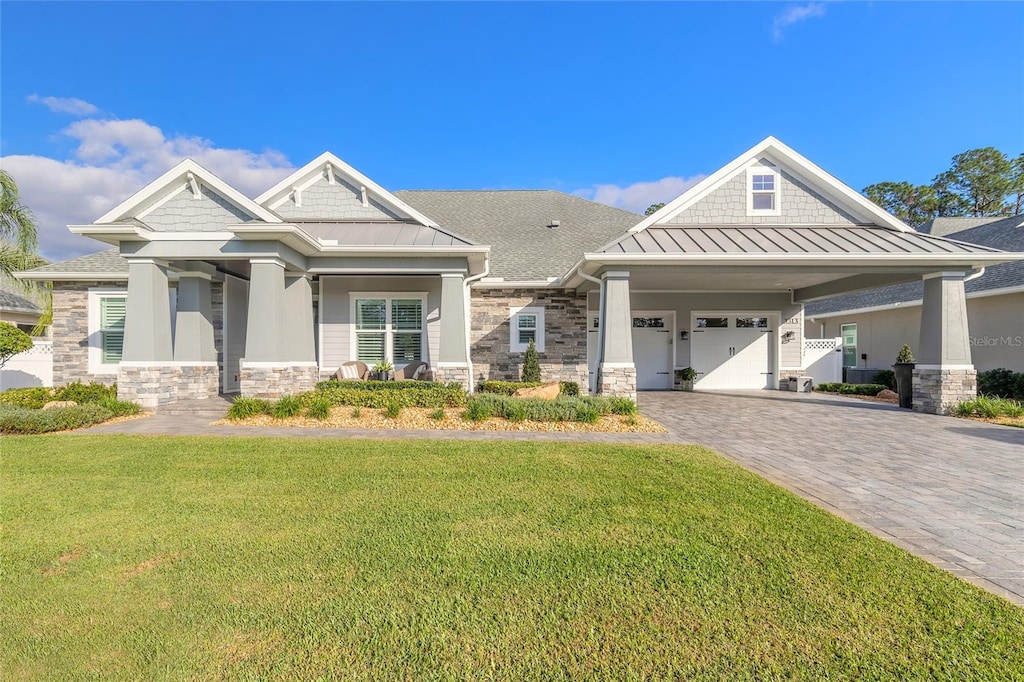 craftsman-style house featuring a front yard and a garage