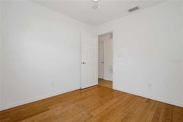 spare room with hardwood / wood-style floors and ceiling fan