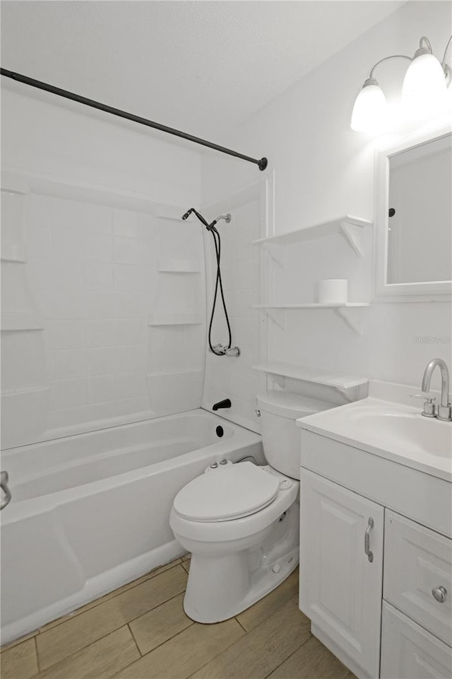 full bathroom with hardwood / wood-style floors, vanity, toilet, and tiled shower / bath combo