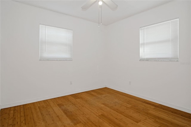 spare room featuring hardwood / wood-style flooring and ceiling fan