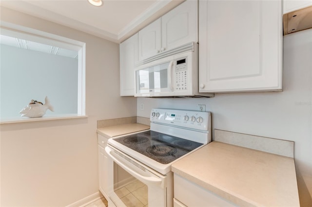 5201 S Atlantic Ave Unit 809A, New Smyrna Beach, FL 32169 - kitchen with white appliances, white cabinetry, light countertops, and light tile patterned floors