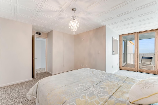 5201 S Atlantic Ave Unit 809A, New Smyrna Beach, FL 32169 - carpeted bedroom with baseboards, access to outside, a chandelier, and an ornate ceiling