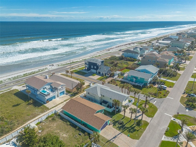 bird's eye view featuring a view of the beach and a water view