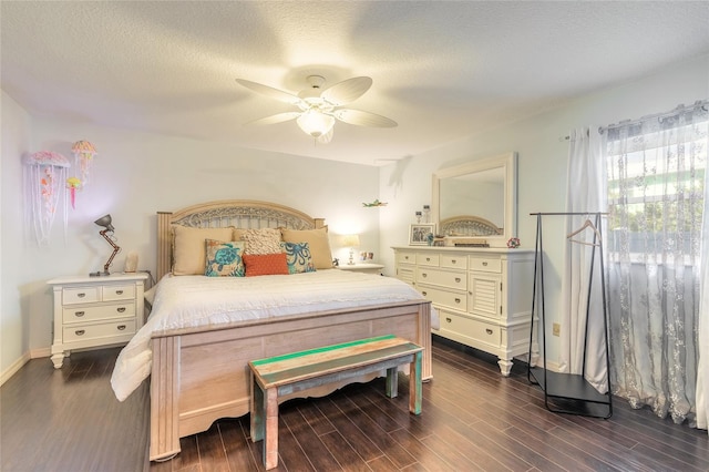 bedroom featuring a textured ceiling, dark hardwood / wood-style flooring, and ceiling fan