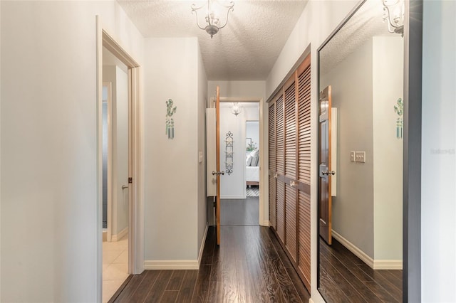 hall featuring dark hardwood / wood-style flooring and a textured ceiling