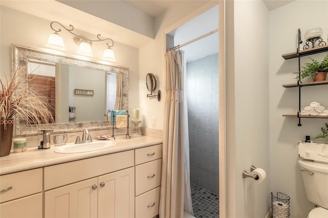 bathroom featuring toilet, vanity, and walk in shower