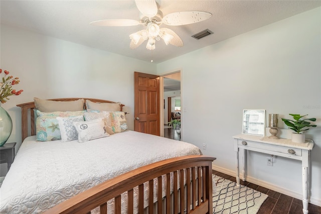 bedroom with ceiling fan and dark wood-type flooring