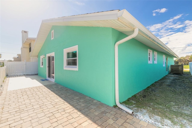 view of side of property with a patio