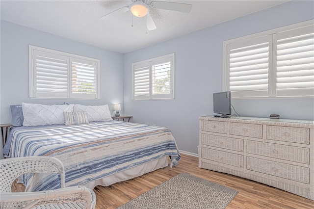 4017 Saxon Dr, New Smyrna Beach, FL 32169 - bedroom featuring multiple windows, wood finished floors, and ceiling fan